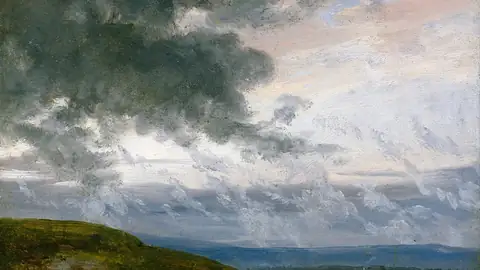 Imagem ilustrativa: Céu nublado sobre colina e mar